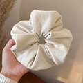 Close-up of cream white oversized scrunchie showing soft flocking texture and details - Off-white