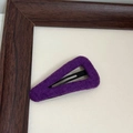 Detailed view of purple felt fabric texture on a minimalist triangular metal hair clip - Purple