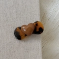 Detail of a brown heart hair clip with tortoiseshell accents on a grey linen background - Heart Tortoiseshell