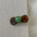 Close-up of a vintage dark green bead and tortoiseshell acetate hair clip on linen - Multi-colored Round Ball