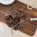 Close-up of brown plaid scrunchie with ribbons on a wooden tray with pearl decor - Light Color Plaid (Type F)