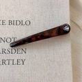 Macro shot of slim tortoiseshell hair clip with dark brown resin texture on fabric - Dark Leopard Thick Straight Style