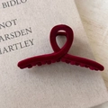 Detail showing the dense flocking texture and cross design of the dark red hair claw clip - Burgundy