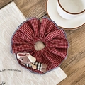 Close-up of red plaid fabric scrunchie with a cute plush bunny doll decoration - Red Plaid