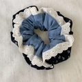 Detailed close-up of triple-layered floral scrunchie with blue fabric and white lace edges - Blue Lace Style