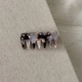 Close-up of tortoise shell acetate hair comb with sparkling rhinestones on linen - Mermaid Gray