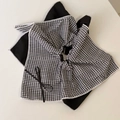 Detail of the black and white gingham fabric texture and small bow on hair accessory - Black Square Towel