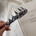 Close-up of black and white plaid headband with punk spike accents for a stylish look - Black Plaid