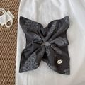 Detail of dark grey paisley scrunchie with resin buckle on premium linen background - Gray