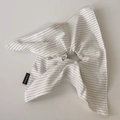 Detailed macro view of handmade striped fabric hair tie with black handmade label - Off-White Scarf Scrunchie