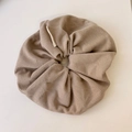 Close-up of beige waffle knit oversized scrunchie texture with professional side label - Off-white