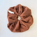 Detail showing knit texture and handmade label on caramel brown oversized hair scrunchie - Brown