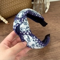 Detail of bohemian floral headband featuring a twist knot design and purple crochet edges - Blue & White Floral Twist