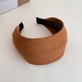 Detail shot of brown suede wide headband showing the soft texture and curved design - Camel