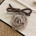 Detailed close-up of a French style knit rose flower hair tie with cream mesh texture - Beige