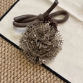Close-up of handmade dark brown knitted rose hair tie with intricate mesh texture detail - Brown