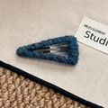 Close-up of a blue wool knit triangular hair clip with vintage tweed texture - Triangle / Blue