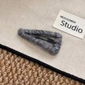 Macro shot of knitted wool texture on a triangular metal snap hair clip for styling - Triangle / Gray