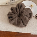 Close-up of a large dark brown plush scrunchie with soft faux fur texture for winter - Brown