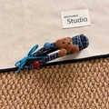 Detail of navy blue plaid BB hair clip with plush bear and blue ribbon bow decor - Bear Claw Clip