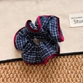 Detail view of navy blue plaid scrunchie with velvet trim and retro British style pattern - Plaid Scrunchie