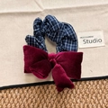 Navy blue plaid scrunchie with a velvet wine red bow hair tie in a top view shot - Bow Scrunchie