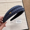 Detailed view of navy blue plaid headband with a gold metal Make a Wish charm - Plaid Headband