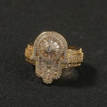 Macro shot of gold Hamsa hand ring featuring pavé-set zircons on black background - US 8 / Gold