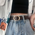 Detail of slim dark brown leather belt with gold oval buckle on denim jeans - 105 / Coffee