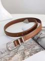 Detailed view of a retro caramel brown leather belt with matte silver pin buckle and rings - Camel