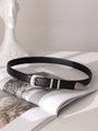 Detail of vintage black leather belt with matte silver buckle and metallic tip accent - Black