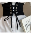 Detail of vintage black corset belt with metallic eyelets paired with white shirt - Black