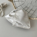 Detail of cream silk hair clip with rose embossing and elegant satin texture finish - Off-white