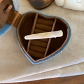 Detail of handmade acetate hair clip with ivory marble texture and gold lettering - Apricot Texture