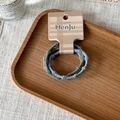 Detailed close-up of green and grey braided hair ties on elegant beige brand tags - 2 Piece Set (XY-1221) / Blue Green Gray