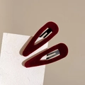 Detail showing two wine red velvet water drop hair clips on textured white paper card - Burgundy