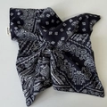 Close-up of navy blue paisley bandana fabric with a white handmade stitched label - Navy Blue Scarf Scrunchie