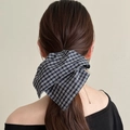 Elegant blue and white checkered bow scrunchie shown on long hair for a stylish look - Black and White Checkered Bow Scrunchie
