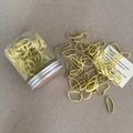 Detail of light yellow elastic hair ties with clear storage jar and metal lid - Yellow