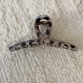 Detailopname van haarklem met schildpadmotief van hars en metalen veerstructuur - Grijs Luipaard Kruis Stijl