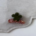 Detail view of flower hair claw clip with olive petals and pink marble resin base - Green Flower