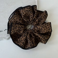Vue détaillée du chouchou léopard marron foncé avec une texture de tissu douce et souple - Chouchou Café Foncé