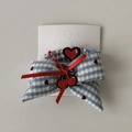 Detail of blue gingham hair scrunchie with heart embroidery and red ribbon on display card - Hair Clips Set B