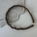 Detail showing leopard print headband with small black hair clips on a fabric base - Dark Coffee Headband