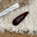Detailed view of a dark burgundy velvet waterdrop snap clip on textured fabric background - Teardrop / Burgundy