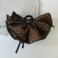 Detail of leopard print bow hair claw clip with black ribbon on a white desk - Dark Coffee Bow Claw Clip