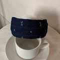 Detail of dark blue denim headband with light blue star embroidery over coffee cup - Dark Blue