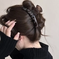 Dettaglio di un grande fermaglio per capelli a tartaruga su uno chignon di modella - Stile Barra Tartaruga Grigio