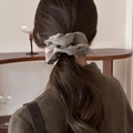 French vintage taupe fabric scrunchie worn on a ponytail in a cozy home setting - Grey-Beige