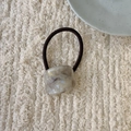 Detail of marble pattern resin block and brown elastic hair tie on knit fabric - Grey Lavender